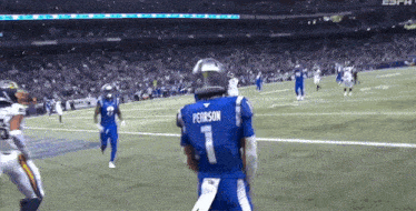 a football player wearing a blue jersey that says pererson on it