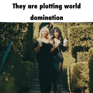 two women walking down stairs with the words they are plotting world domination below them