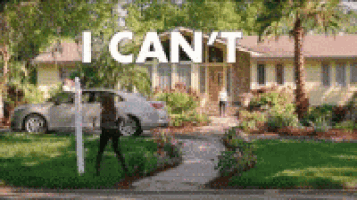 a woman is standing in front of a house that says i can 't