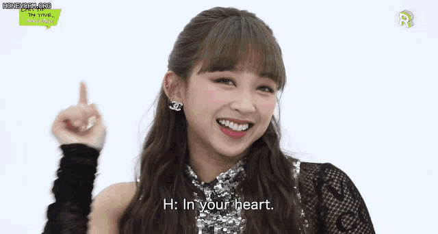 a woman is smiling and pointing up at the camera while saying hi in your heart