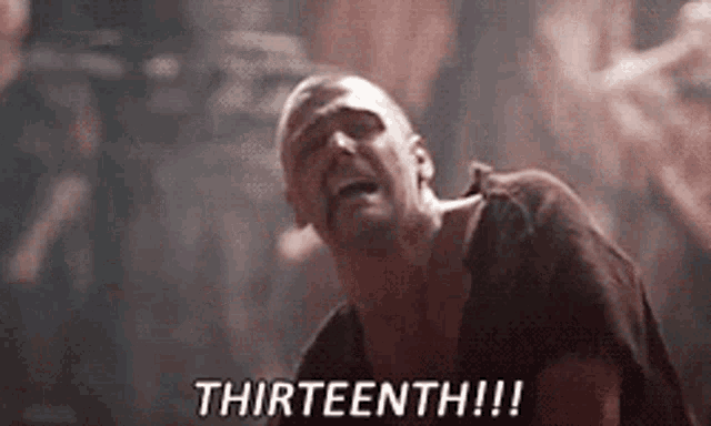 a man is screaming with the words thirteenth written on the screen behind him .