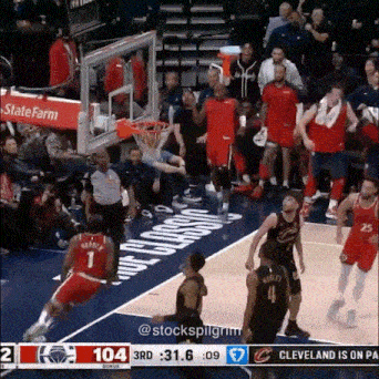 a basketball game is being played in a stadium with a state farm banner on the stands