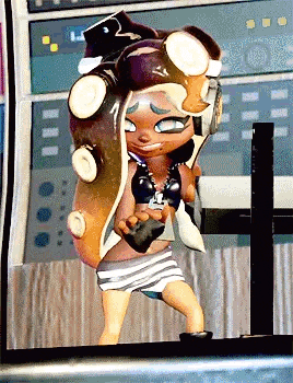 a cartoon character with an octopus head is standing in front of a computer screen .
