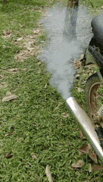 a motorcycle with smoke coming out of its exhaust pipe
