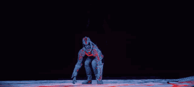 a person in a red and blue suit with a glowing face is standing in the dark