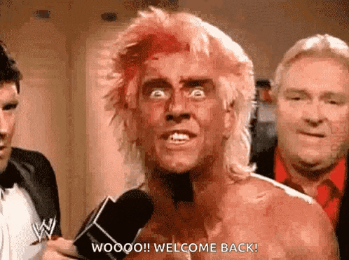 a man with a bloody face is talking into a microphone and says welcome back .