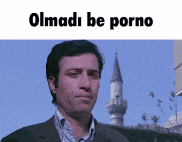 a man in a suit stands in front of a blue sky with the words " olmadi be porno " above him