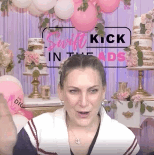 a woman is standing in front of a sign that says kick in the ads