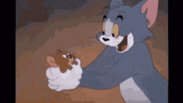 a cartoon cat is holding a small mouse in his paws .