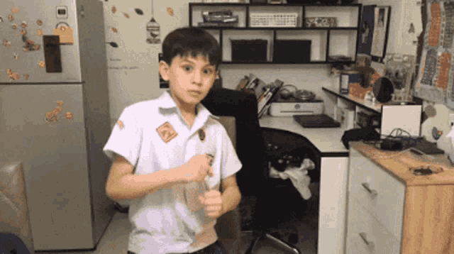 a boy standing in front of a refrigerator with a sticker on it that says ' lg '