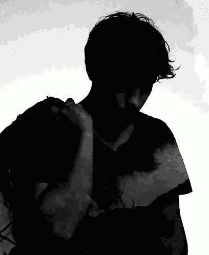 a black and white photo of a man with a silhouette of a landscape on his shirt
