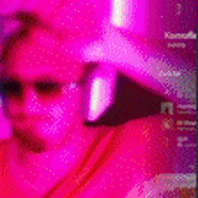 a man wearing sunglasses and headphones is standing in front of pink balloons