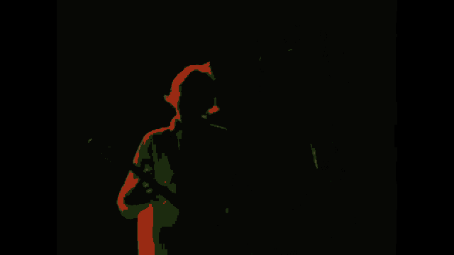 a man playing a guitar and singing into a microphone on a stage