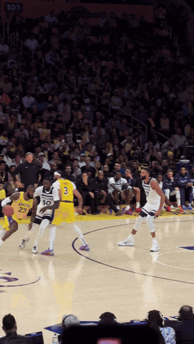 a basketball game is being played in front of a crowd with a player wearing number 30