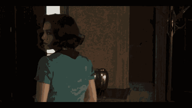 a woman in a blue dress is standing in a room