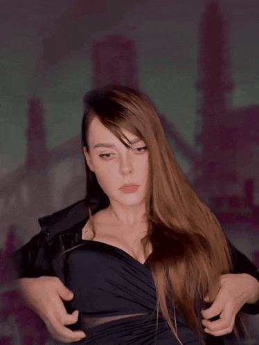 a woman with long hair and a very large breast is wearing a black top