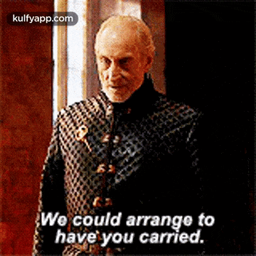 a man with a beard is standing in front of a door and saying `` we could arrange to have you carried '' .