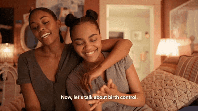 two women are sitting on a bed and one of them says " now let 's talk about birth control "