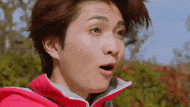 a close up of a man 's face with a surprised look on his face