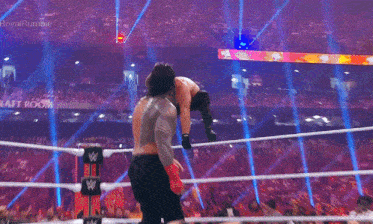 a man in a wrestling ring with the word rumble on the screen