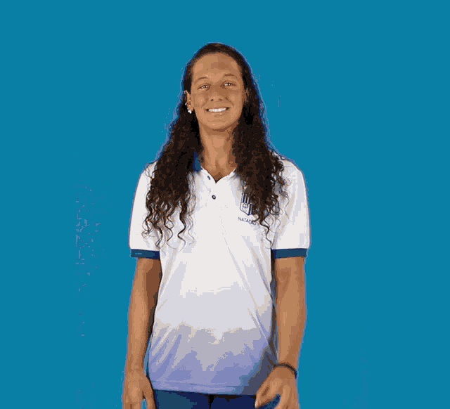 a woman with long curly hair wearing a polo shirt that says ' ucsd ' on it