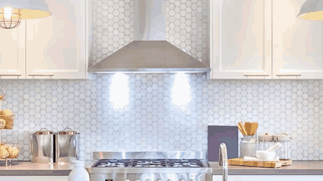 a girl with blue eyes is smiling in front of a stove