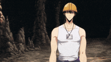 a man wearing a hard hat and a name tag stands in a dark cave