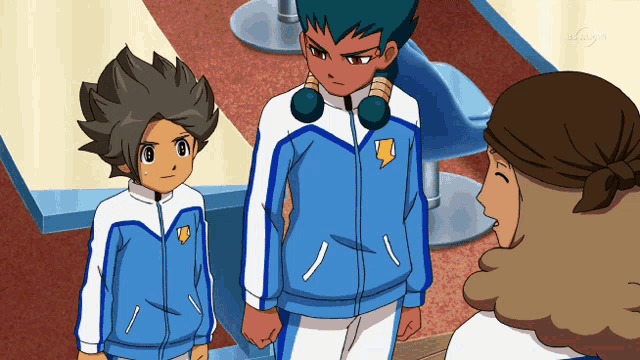 a group of cartoon characters are standing next to each other and one of them has the letter t on their jacket