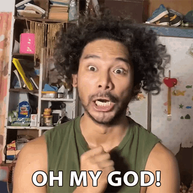 a man with curly hair is making a funny face and says oh my god