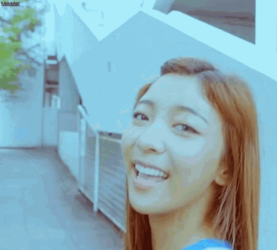 a close up of a woman 's face with the word rainbow on the bottom left