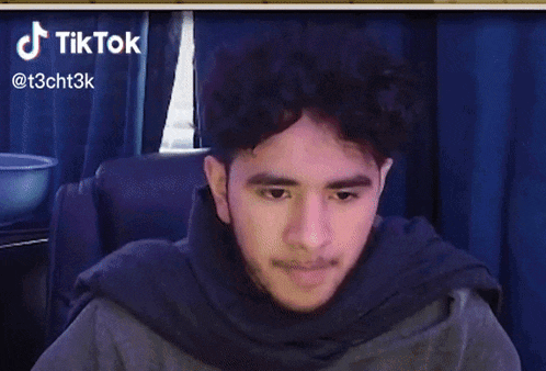a man is sitting in a chair with his eyes closed and a tiktok watermark on the bottom right
