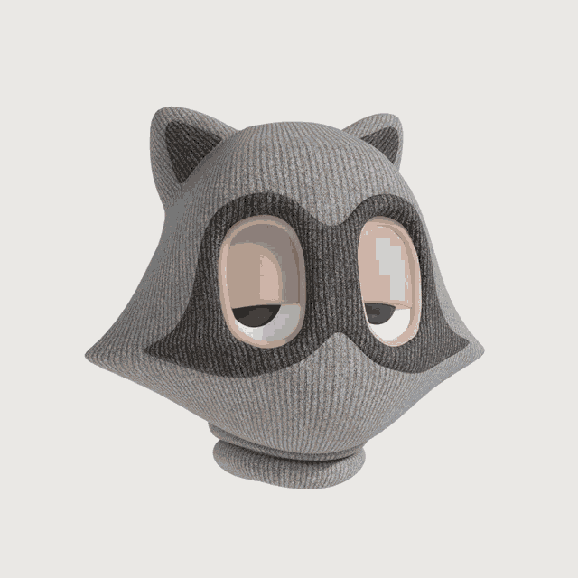 a gray knitted raccoon with big eyes and ears on a white background