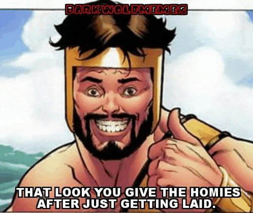 a man with a beard and a helmet is giving a thumbs up .