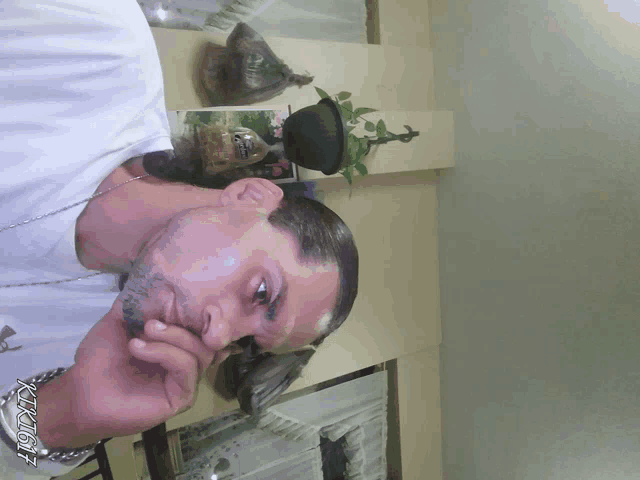 a man in a white shirt with a watch that says ' tk167 '