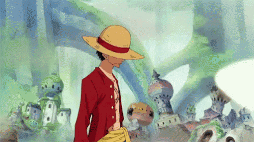 luffy from one piece is wearing a straw hat and standing in front of a castle .