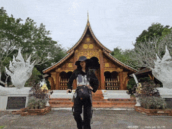 a woman stands in front of a temple with a daily sub written below her
