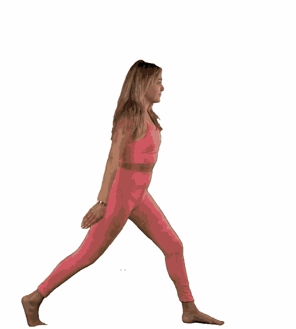 a woman in pink pants and a pink top is doing yoga
