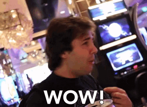 a man in a black shirt with the word wow written on it