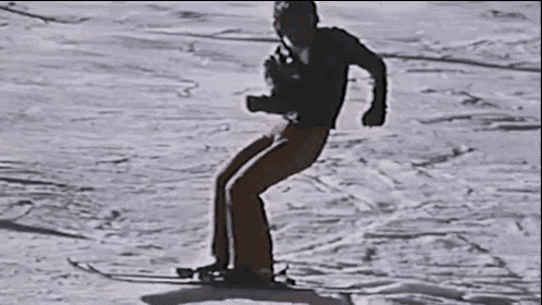 a man is skiing down a snow covered slope on a snowboard .