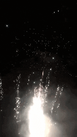 a firework display in the night sky with a lot of sparks