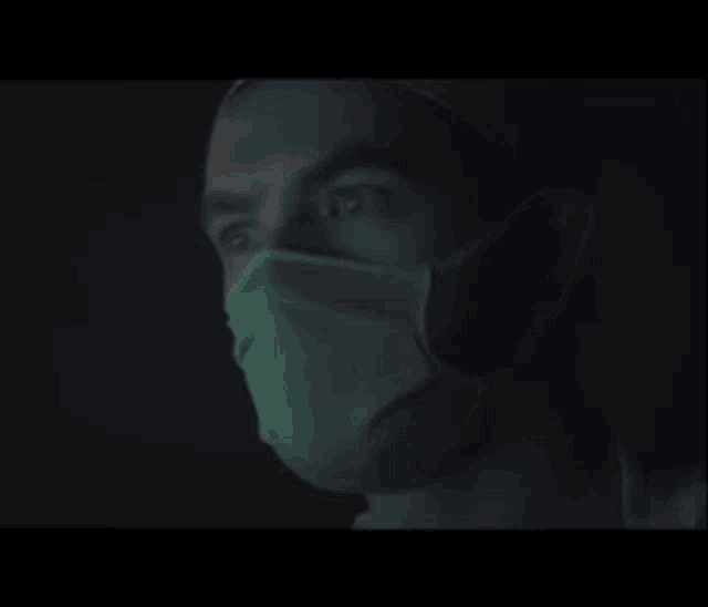 a close up of a man wearing a mask