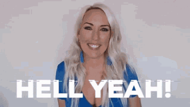a woman in a blue shirt is making a funny face and pointing her finger at the camera .