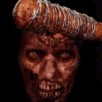 a close up of a zombie 's face with a barbed wire bat on his head