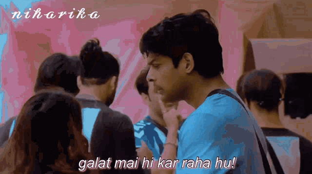 a man in a blue shirt stands in a crowd with the words galat mai hi kar raha hu