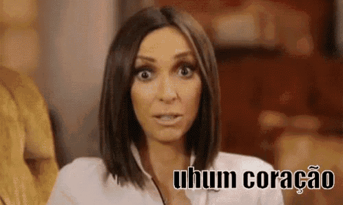 a woman in a white shirt is making a funny face and saying uhum coracao .