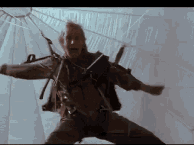 a man in a parachute is falling through the air