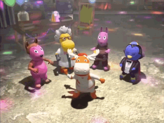 a group of stuffed animals are dancing together in a dark room