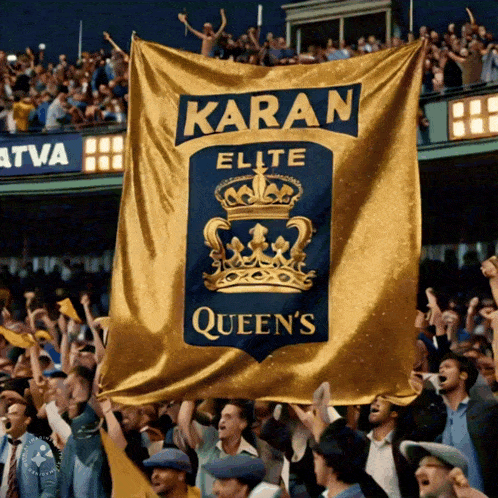 a crowd of people holding up a banner that says karan elite queens