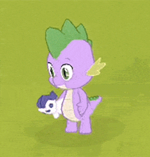 spike from my little pony is holding a stuffed animal in his mouth .