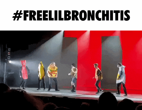 a group of people dancing on a stage with the words #freelilbronchitis behind them